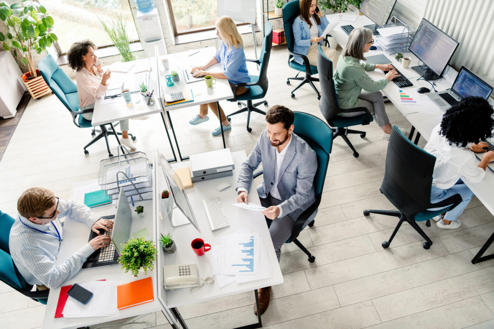 Open-plan office with diverse employees working.